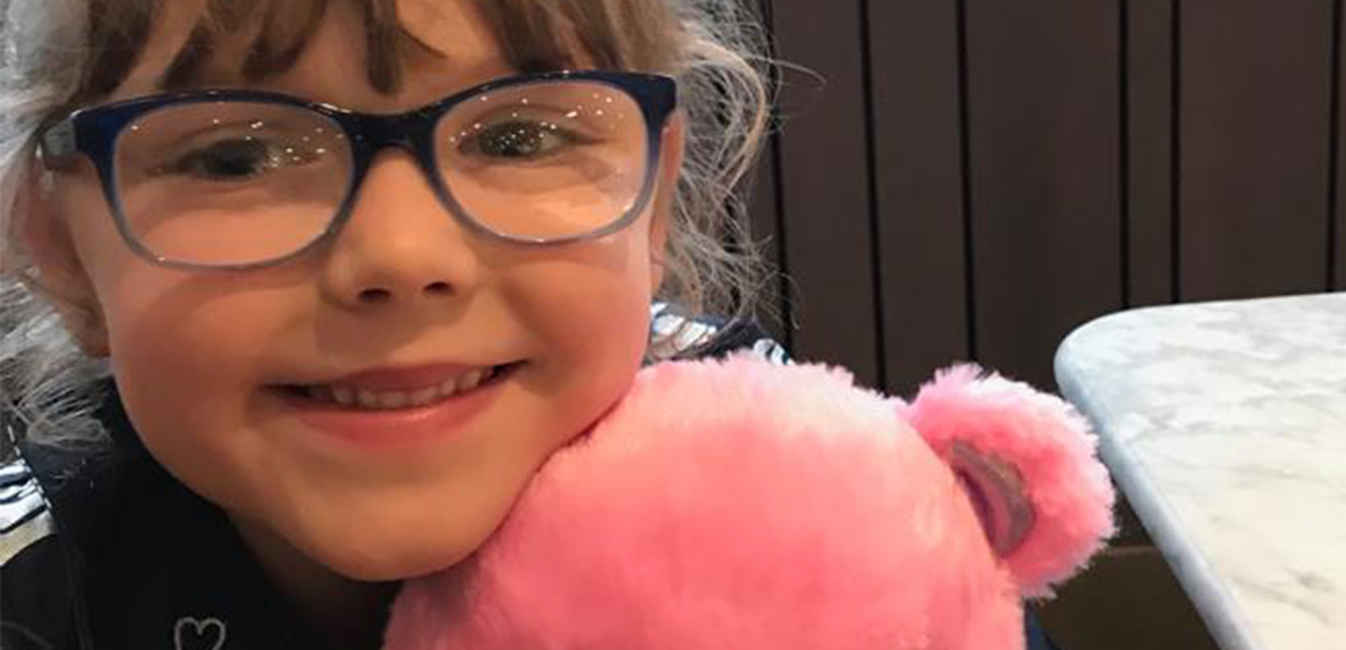 Matilda smiling with pink teddy