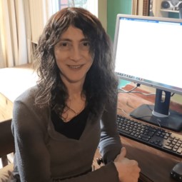 Noemi Lois sitting at desk smiling at camera