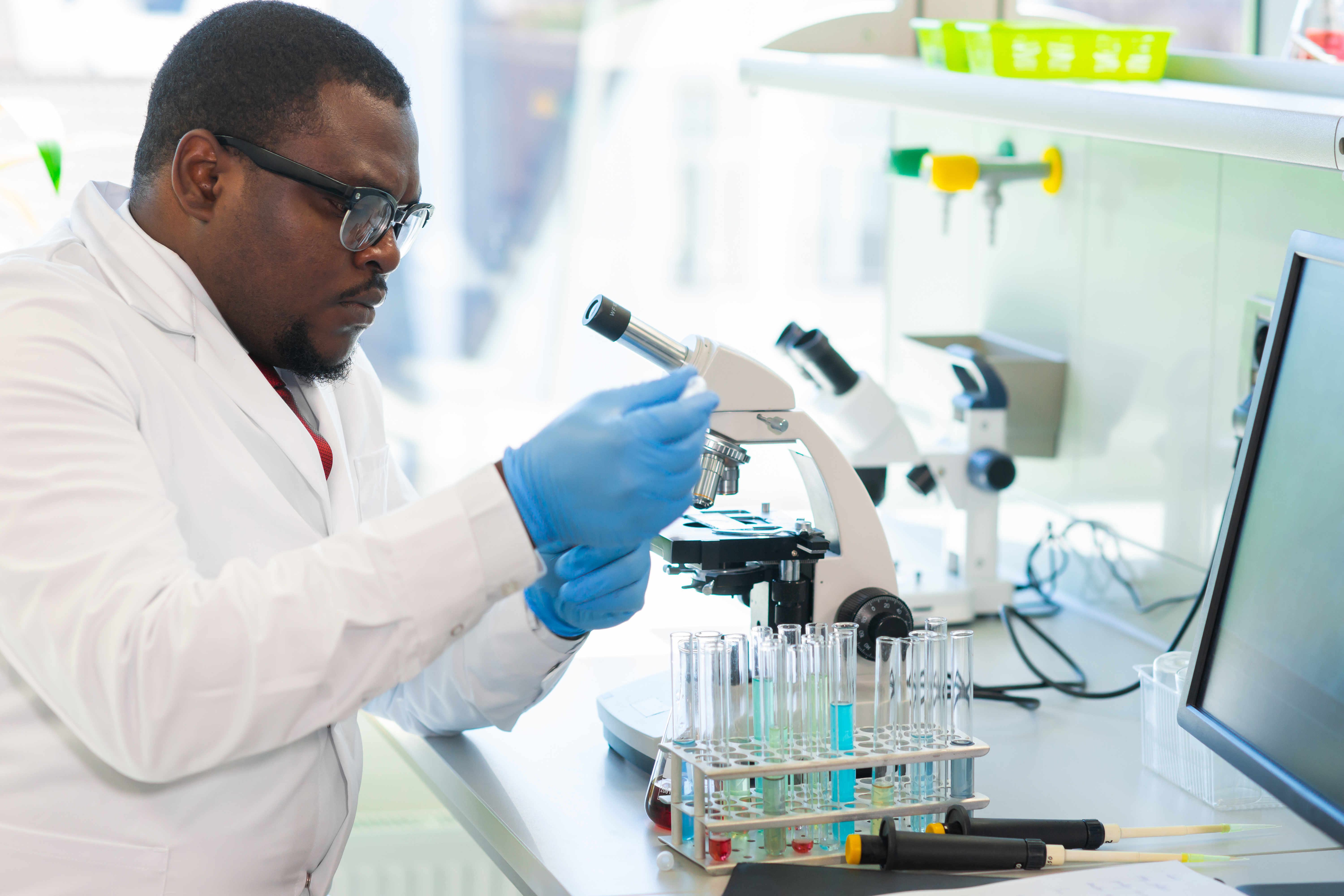 Researcher by microscope