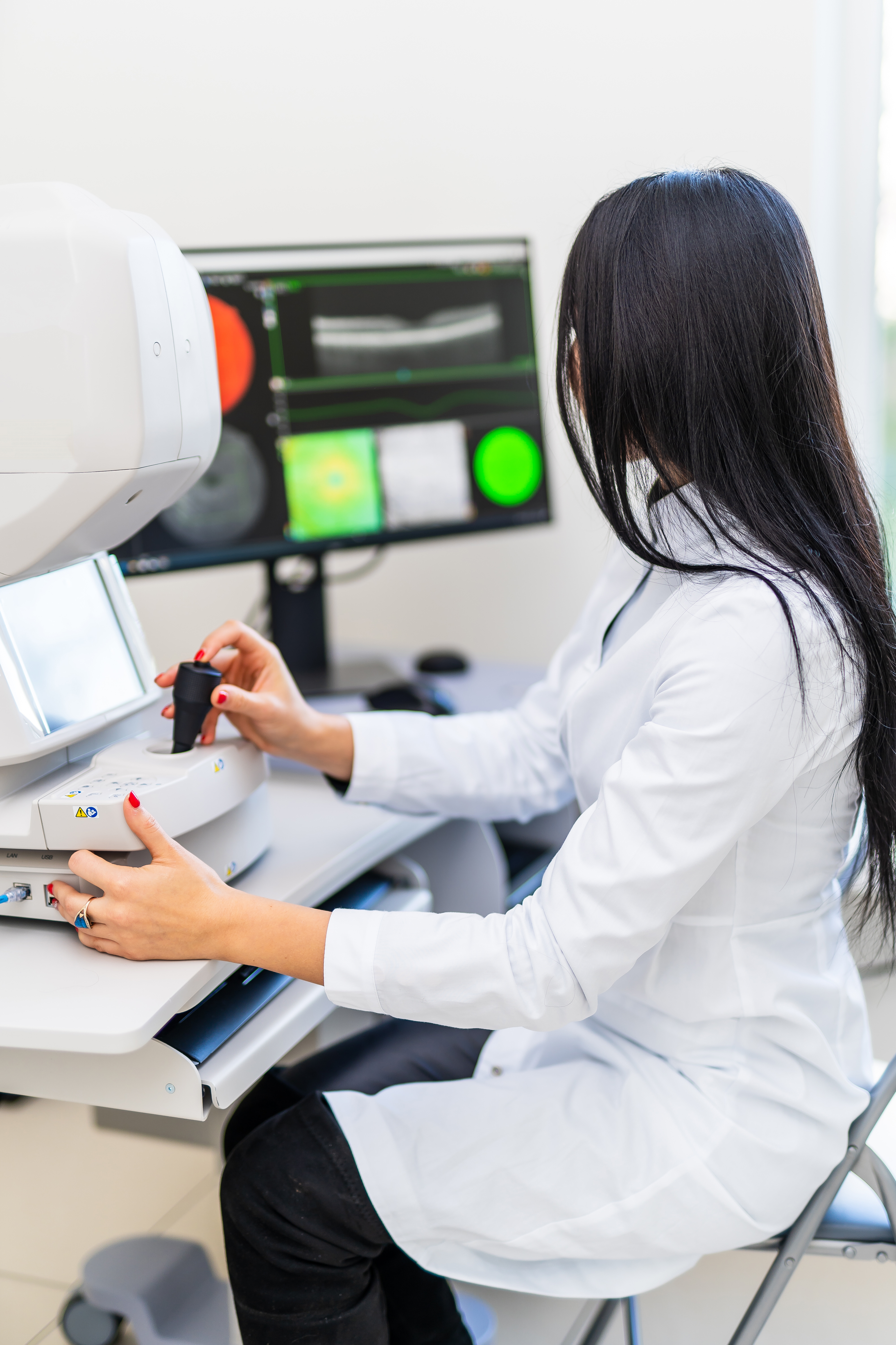 eye test clinic, woman looking at eye scans 