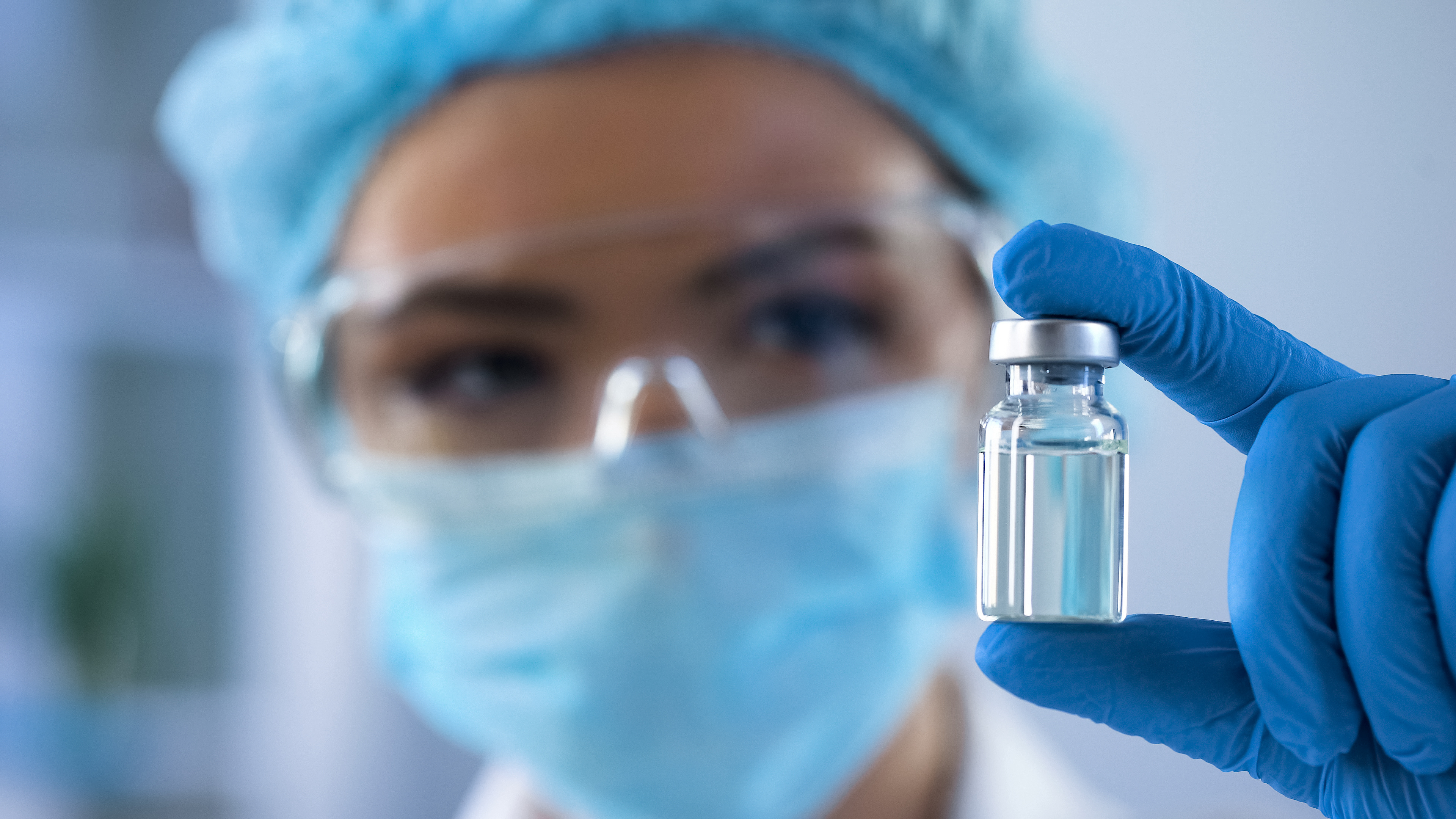 Scientist with drug vial