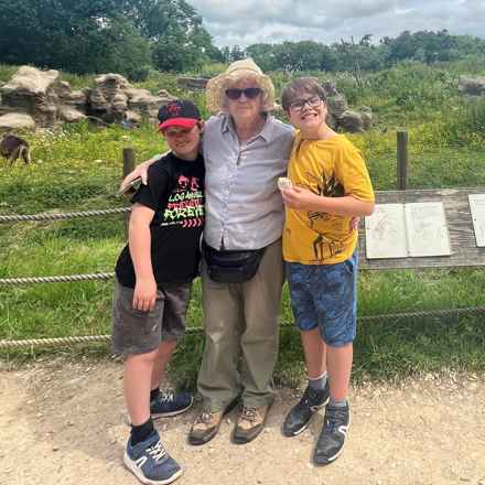 Grinning brothers Bryn and Ioan stand either side of their grandma, Sallie