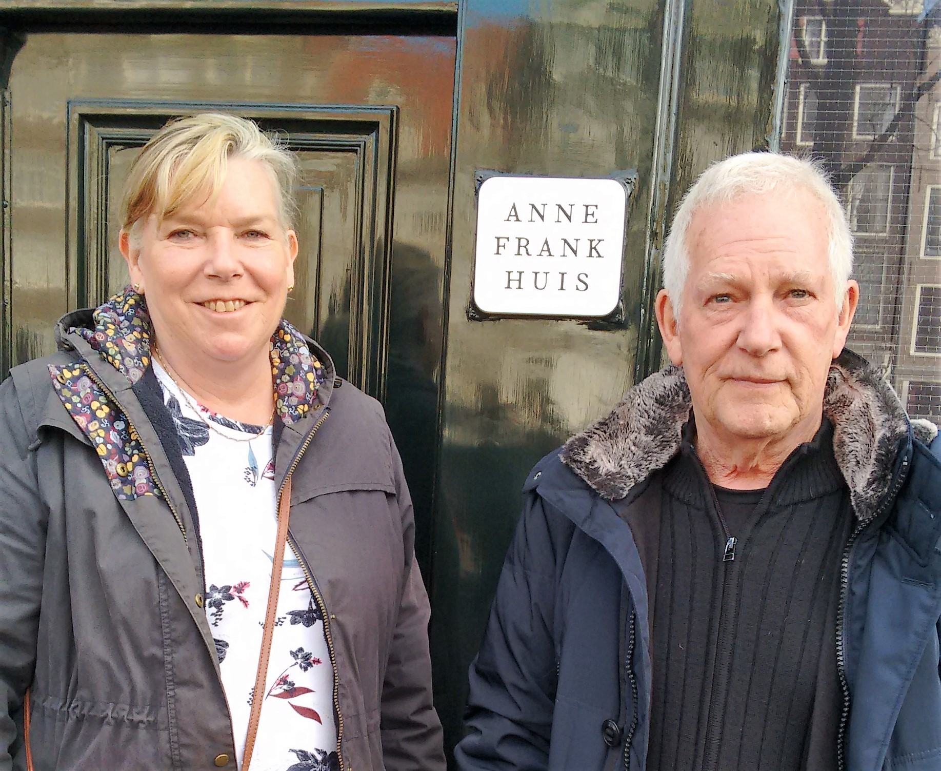 Anne, left, pictured with John on holiday outside the Anne Frank house museum
