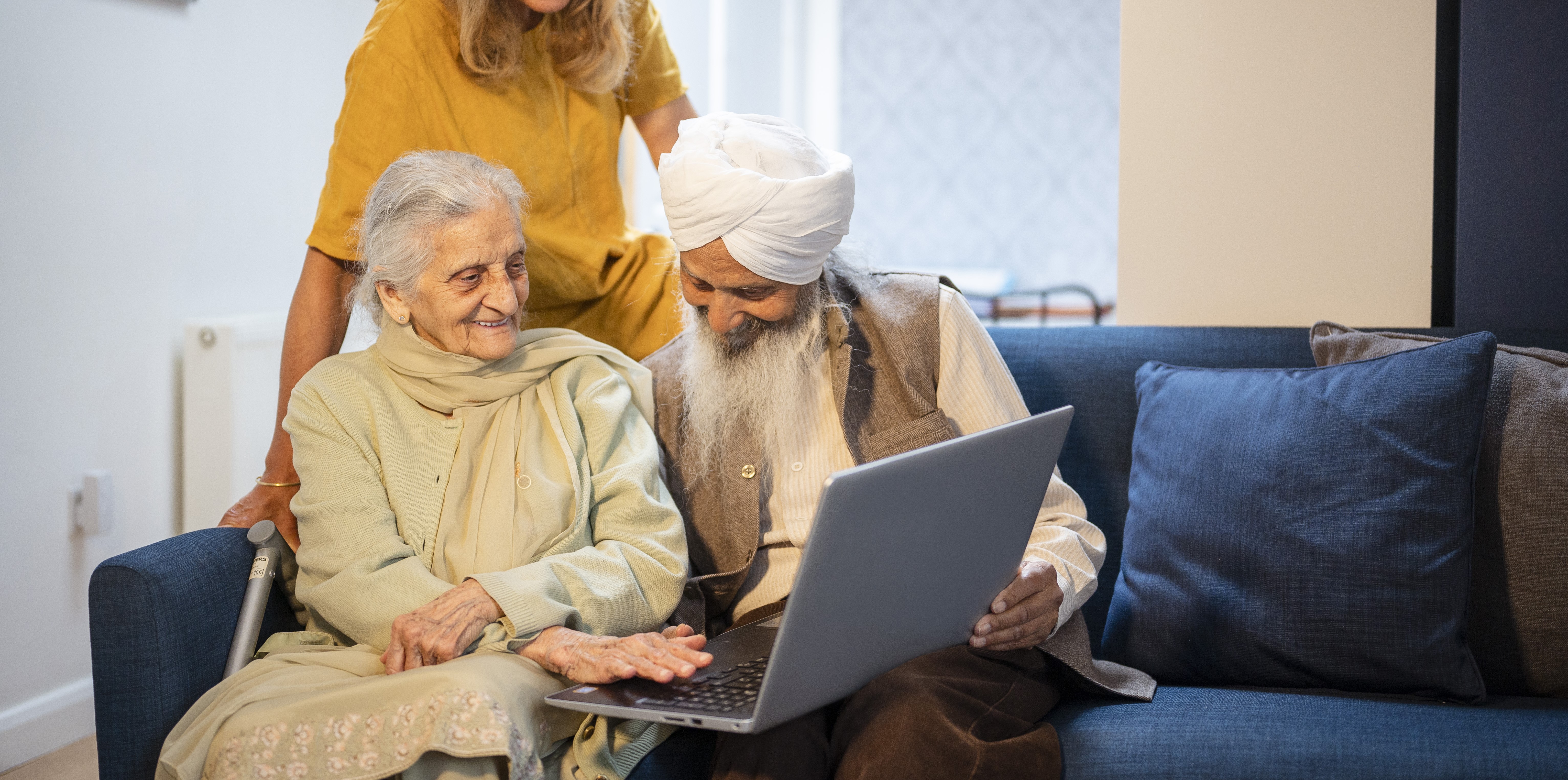 Family looking at laptop