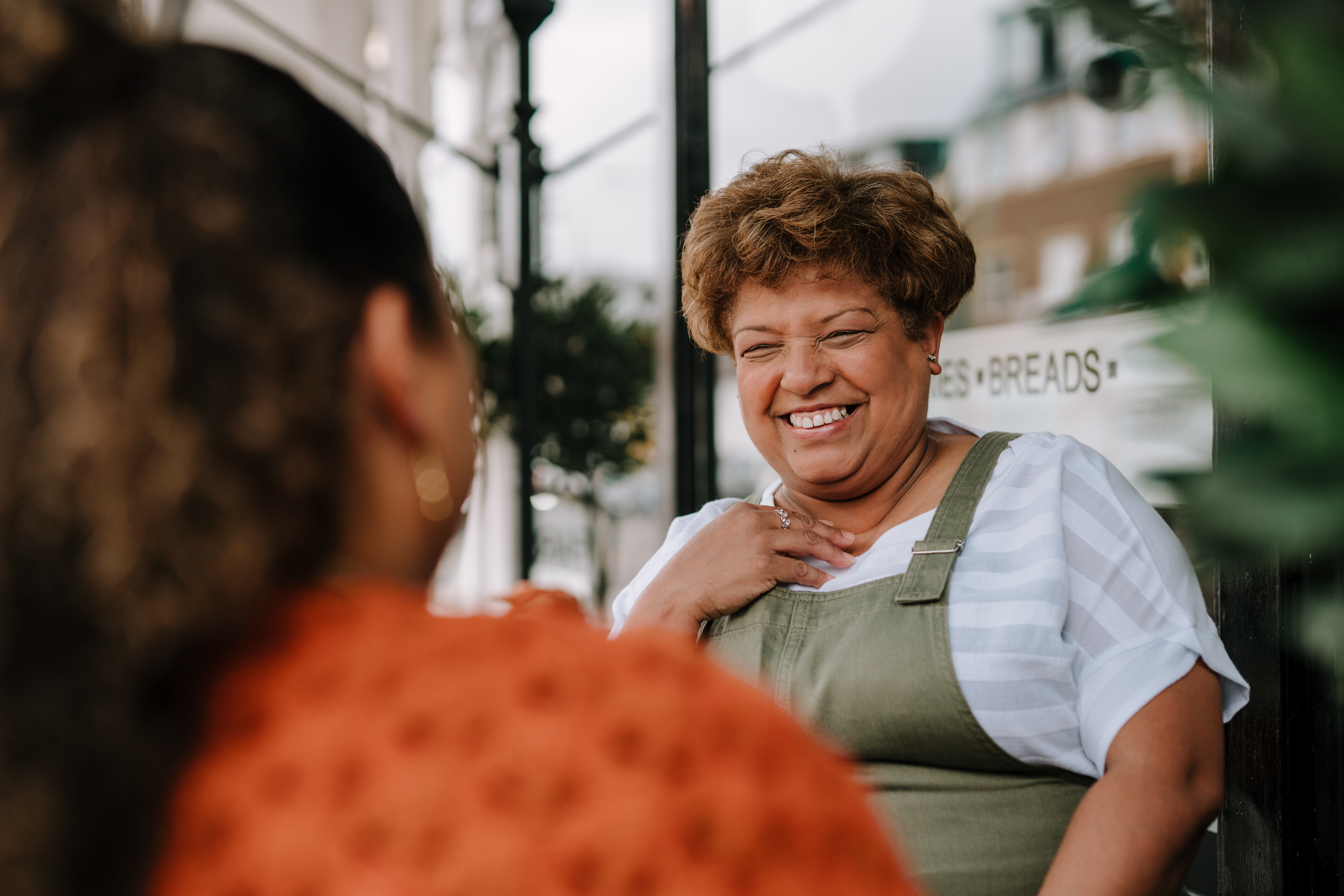 woman smiling outside bakery 