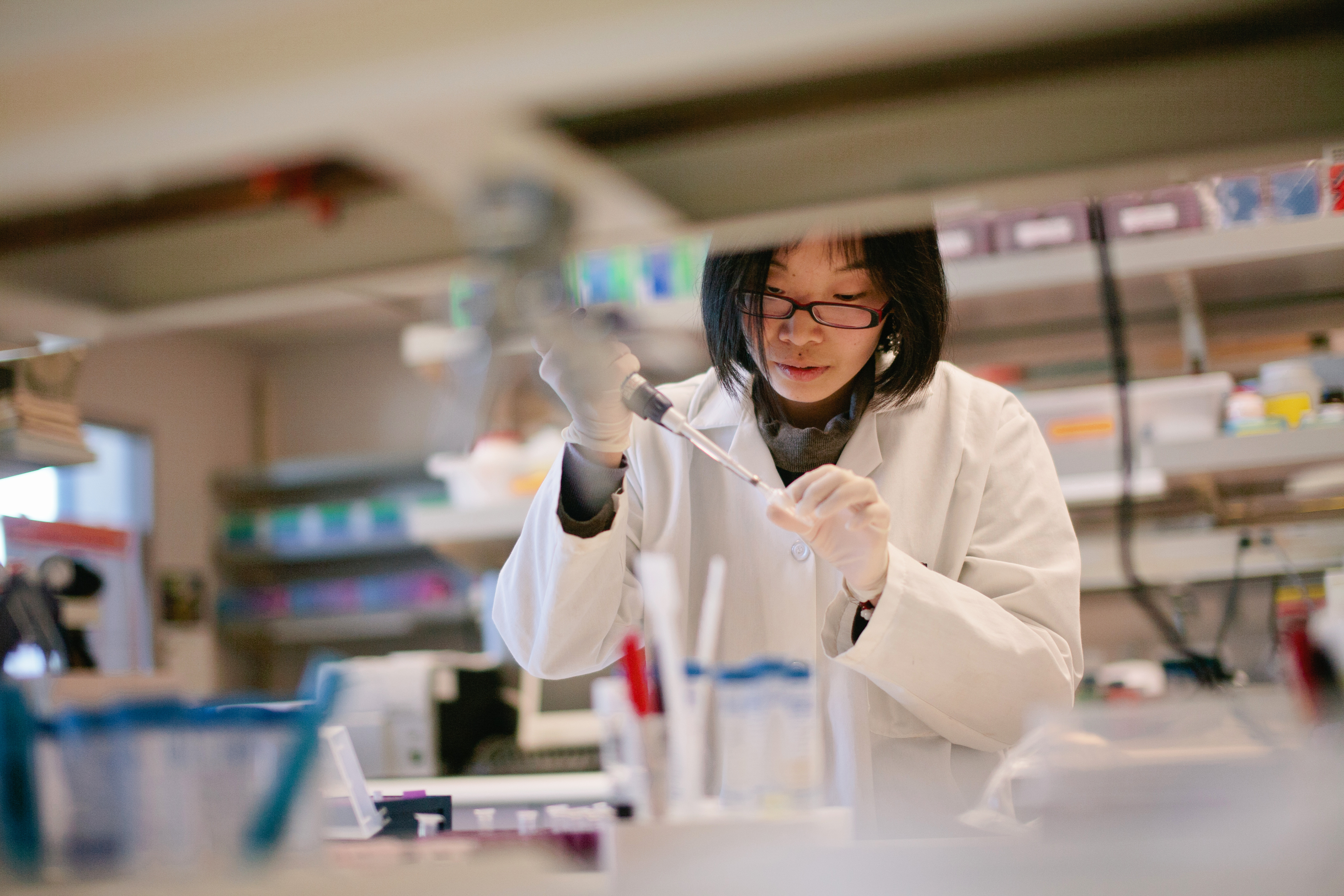 Researcher in laboratory with syringe 
