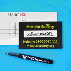 Macular Society signatory guide example use on signed bank cheque with pen