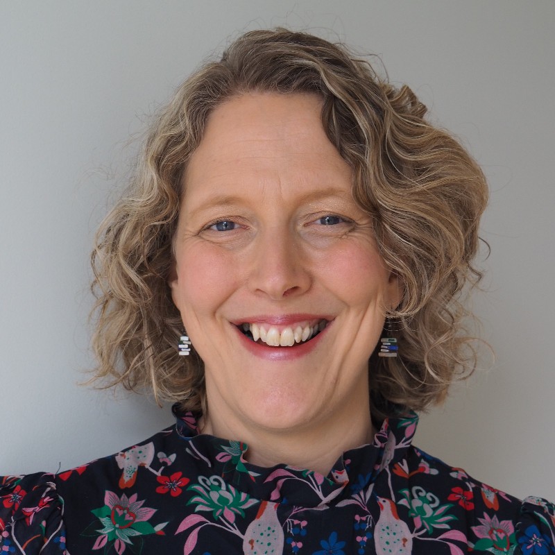 Close up portrait of Professor Ruth Hogg, smiling.