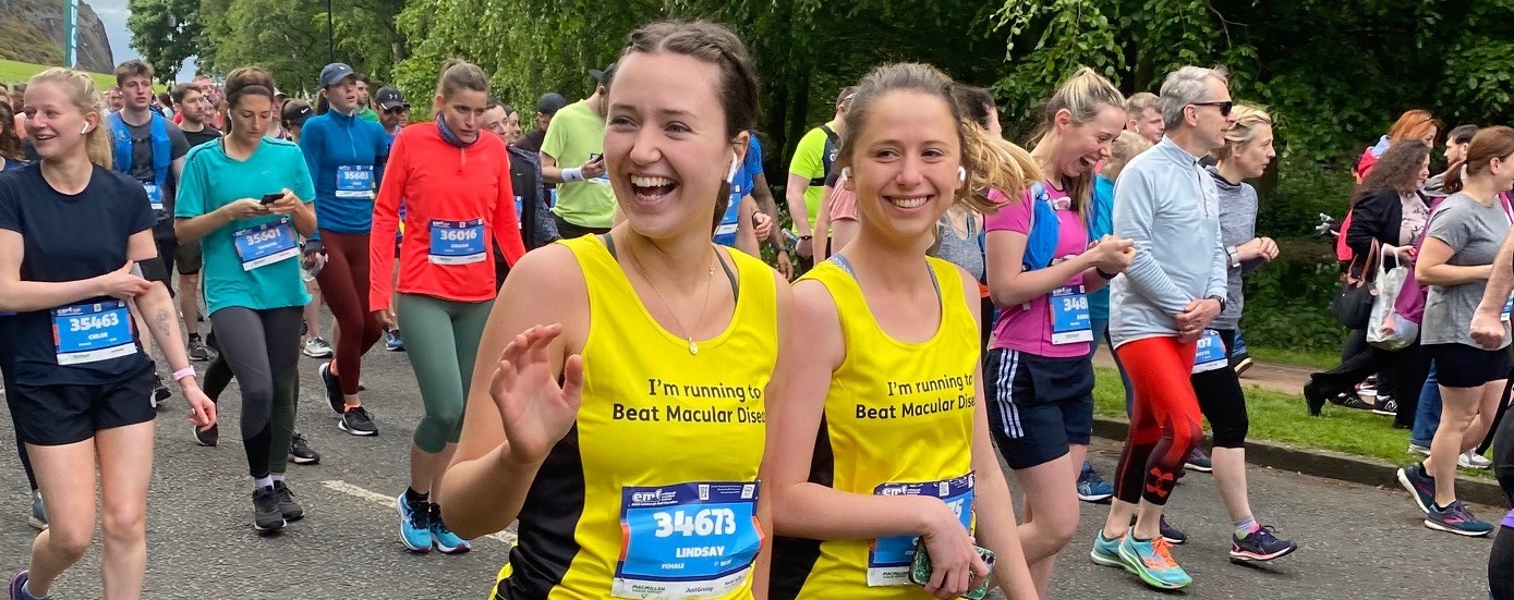 Two women running with Macular Society t-shirts