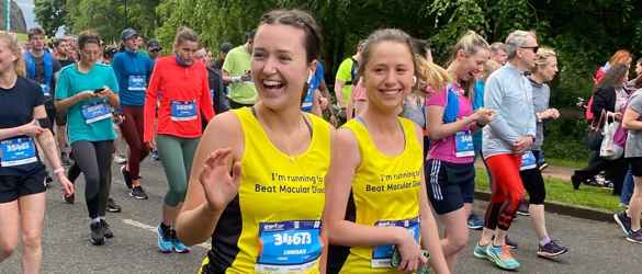 Two women running with Macular Society t-shirts