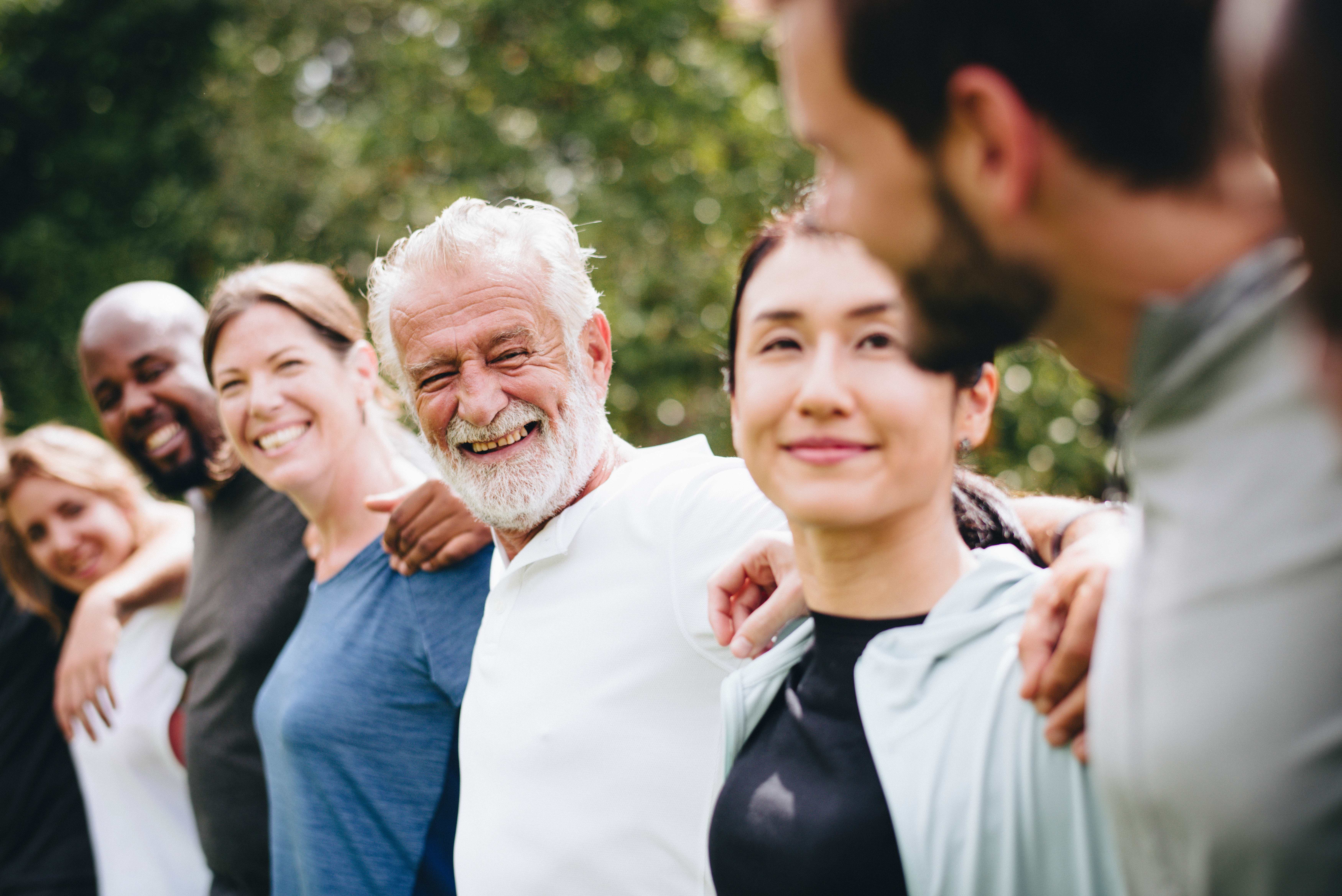 People Smiling arms around each other