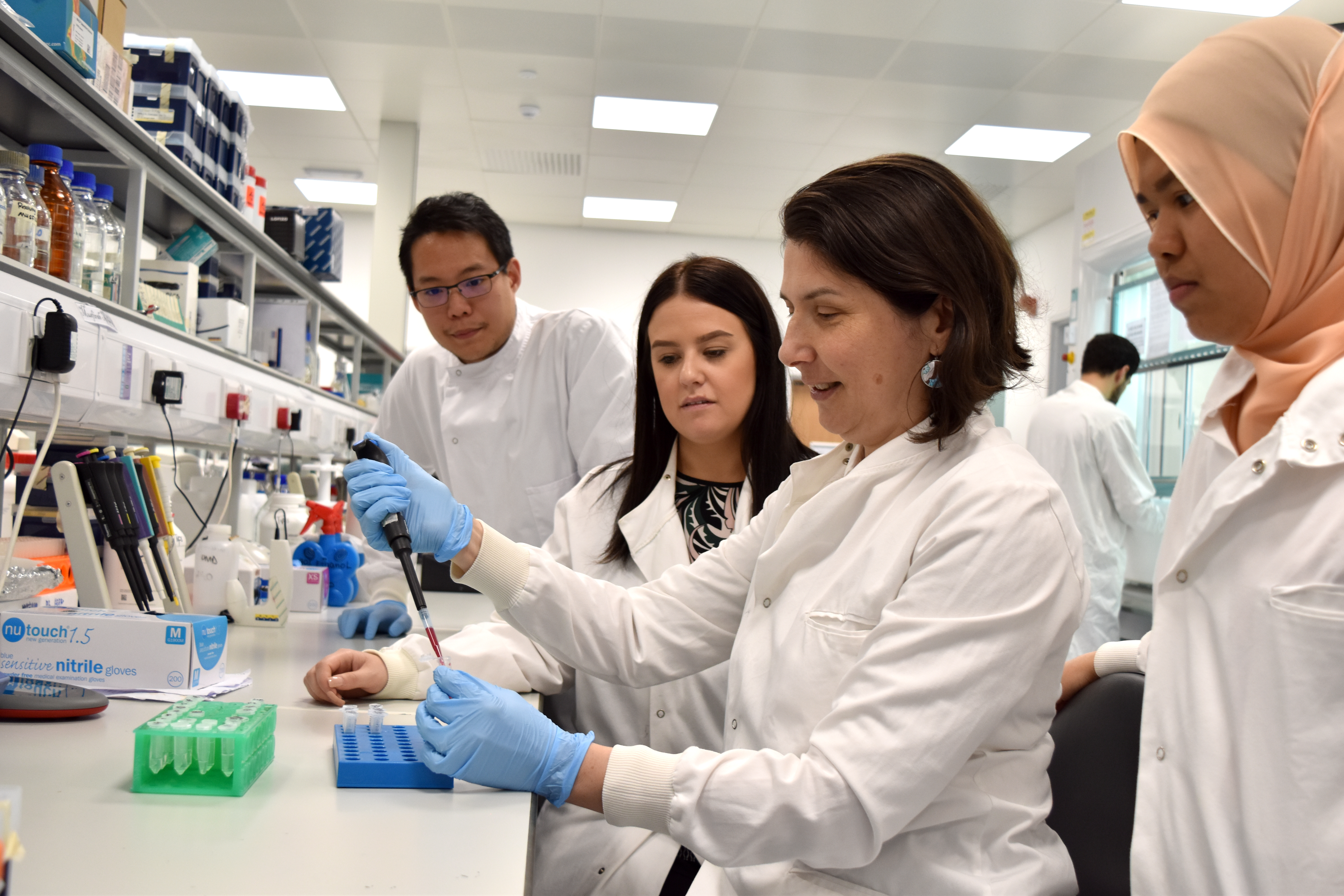 Dr Luminita Paraoan in the laboratory doing a demonstration 