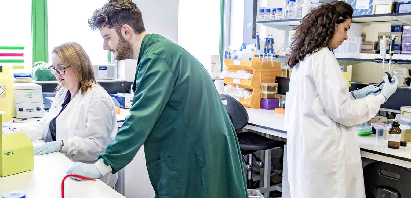 Three Researchers Lab Man in Green Coat