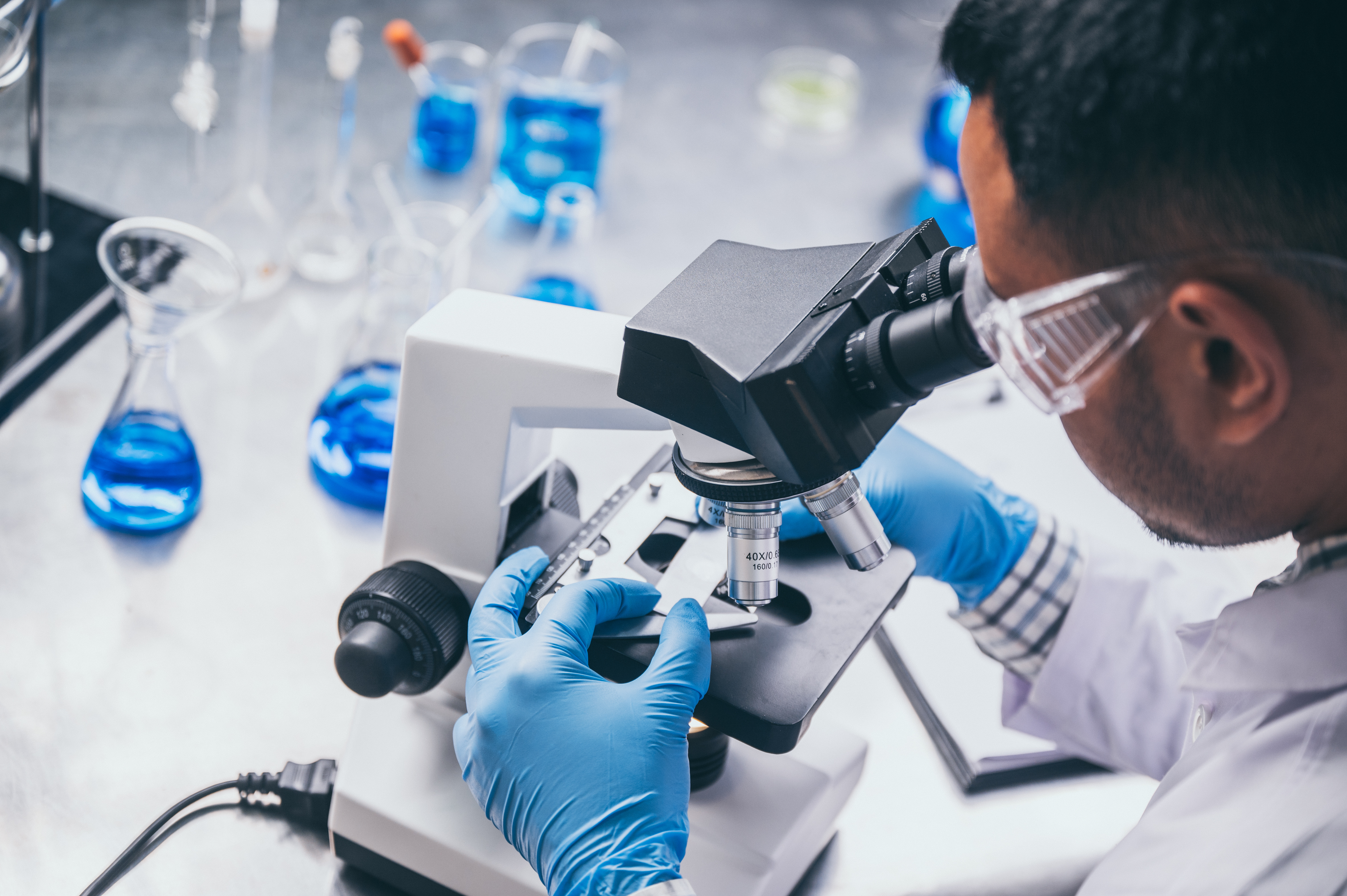 Researcher with a microscope
