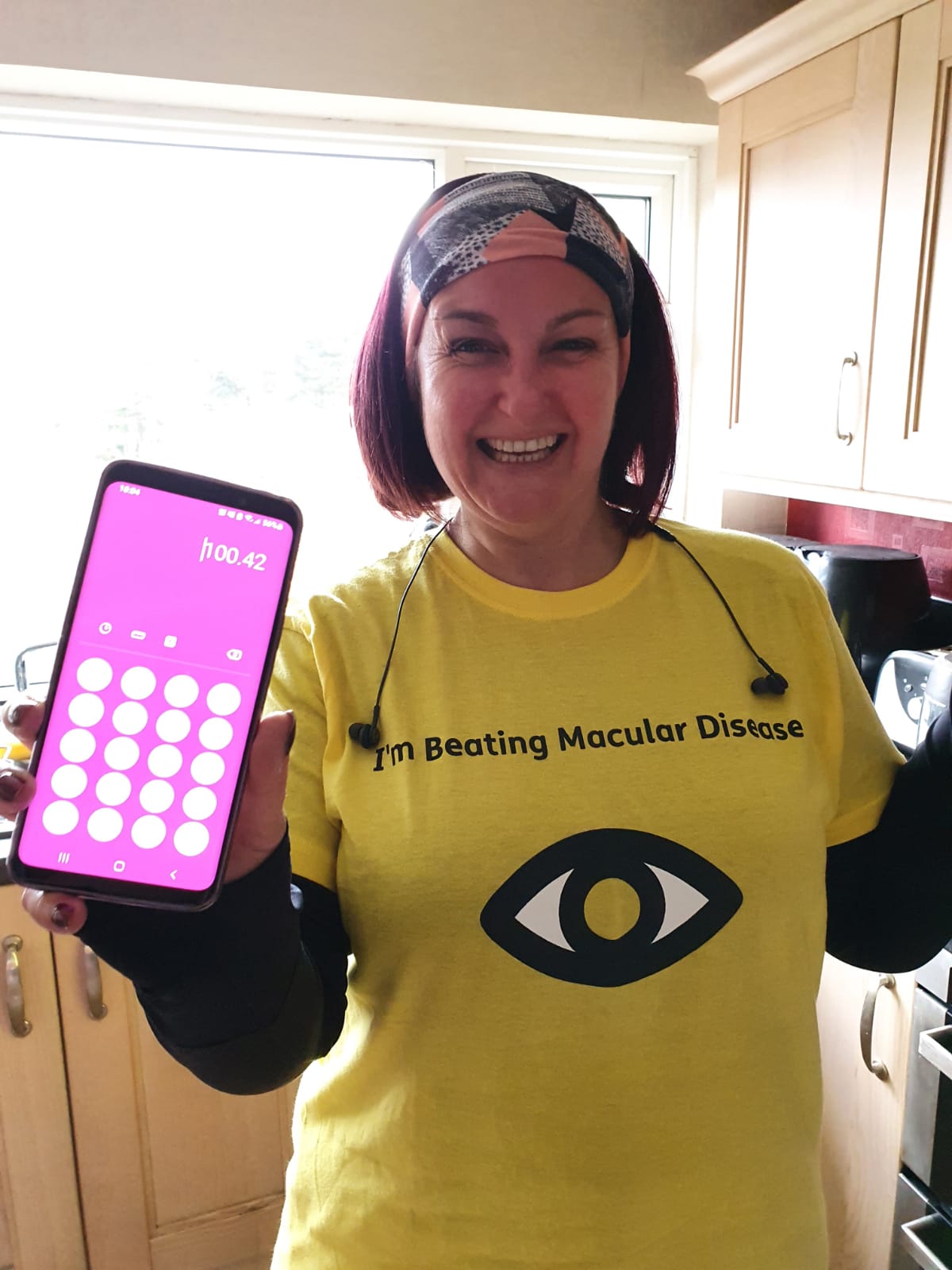 Step Around the World - Lisa Fisher in Macular Society t-shirt with phone