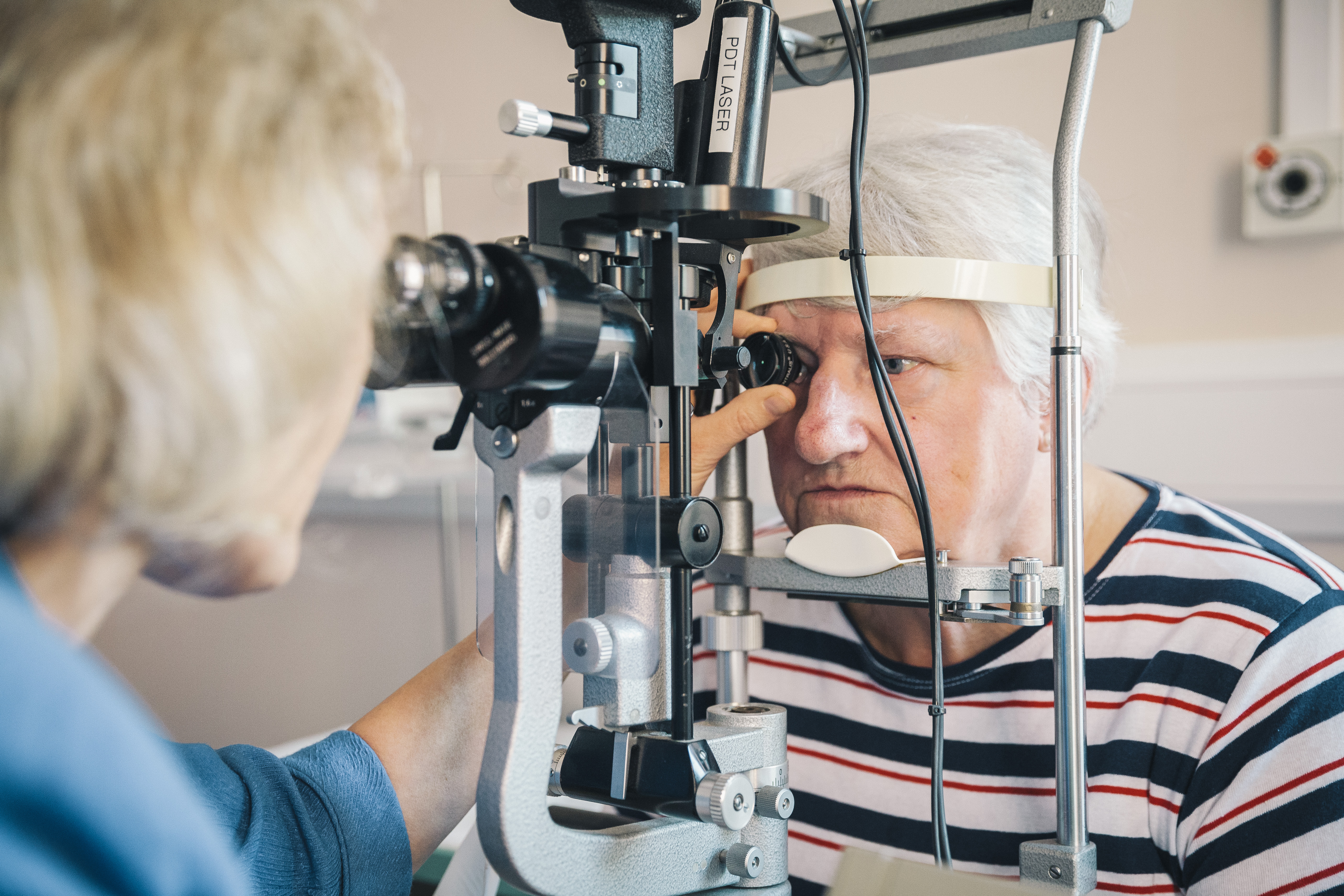 Elderly person having eye test