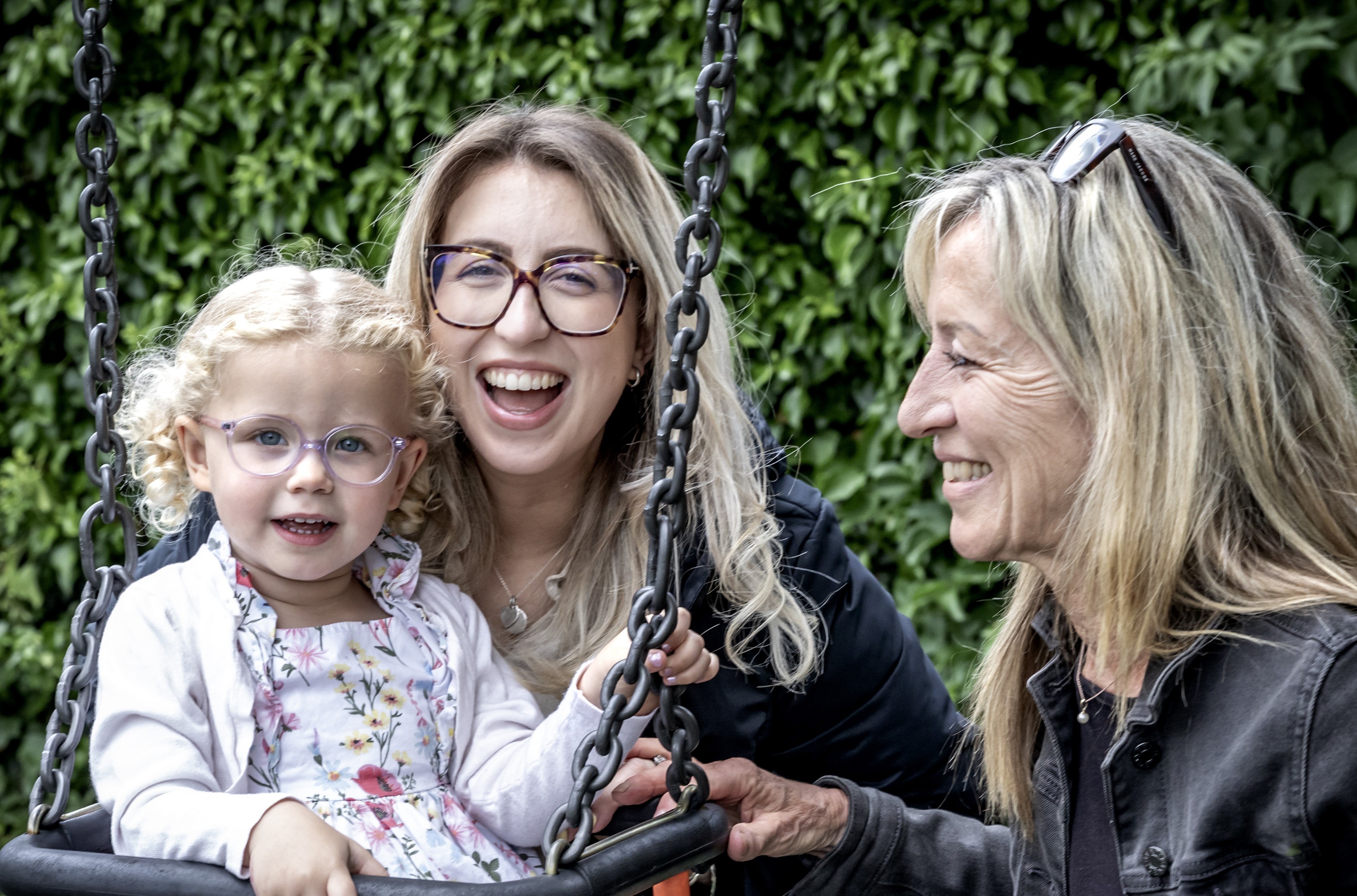 Gill and her daughter and granddaughter smiling and laughing together