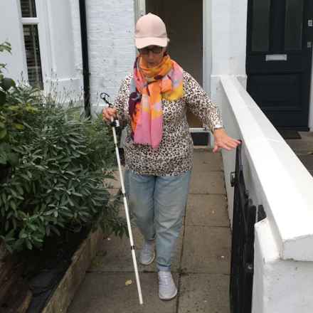 Irene walking outside with stick