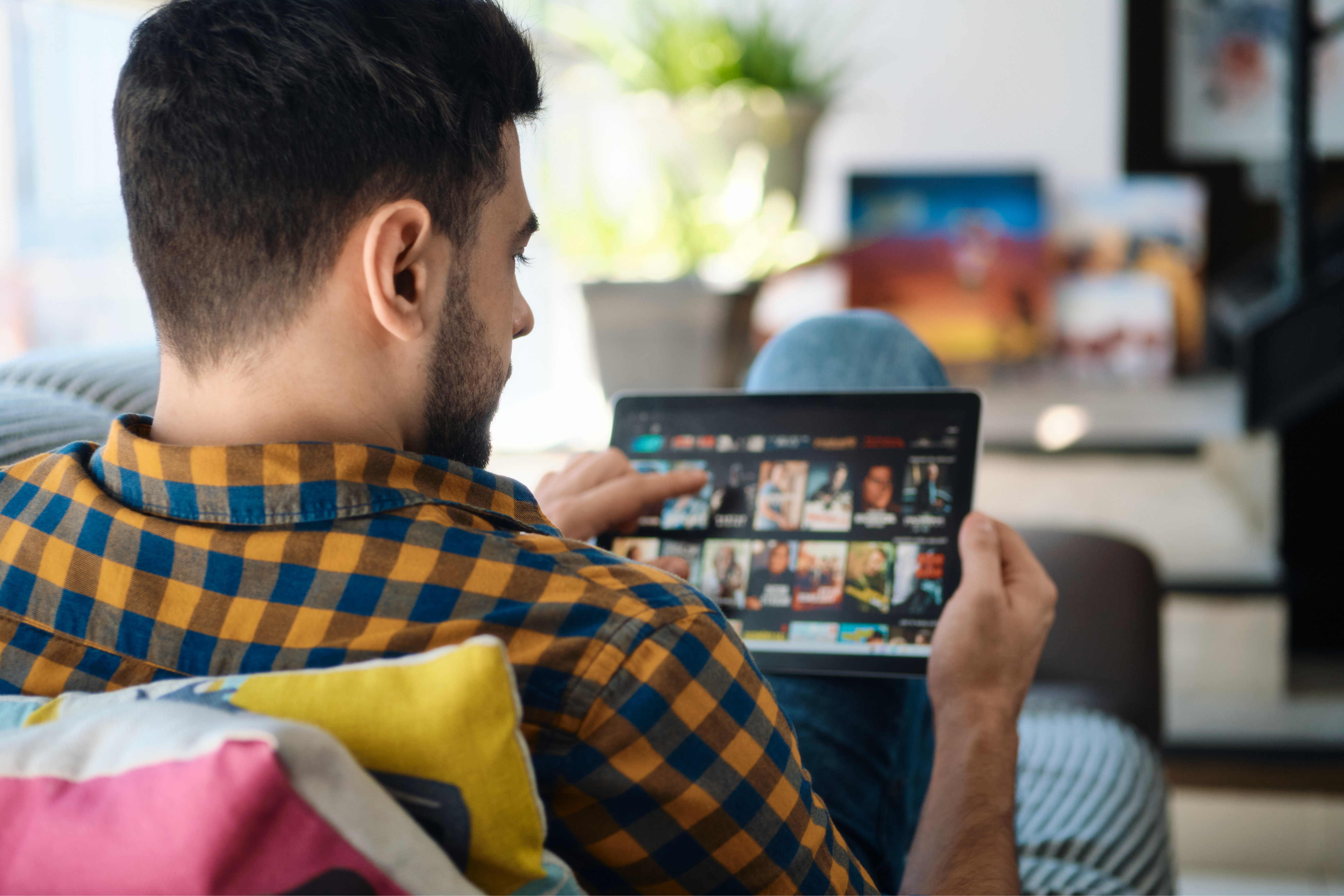 Man sitting on sofa with tablet