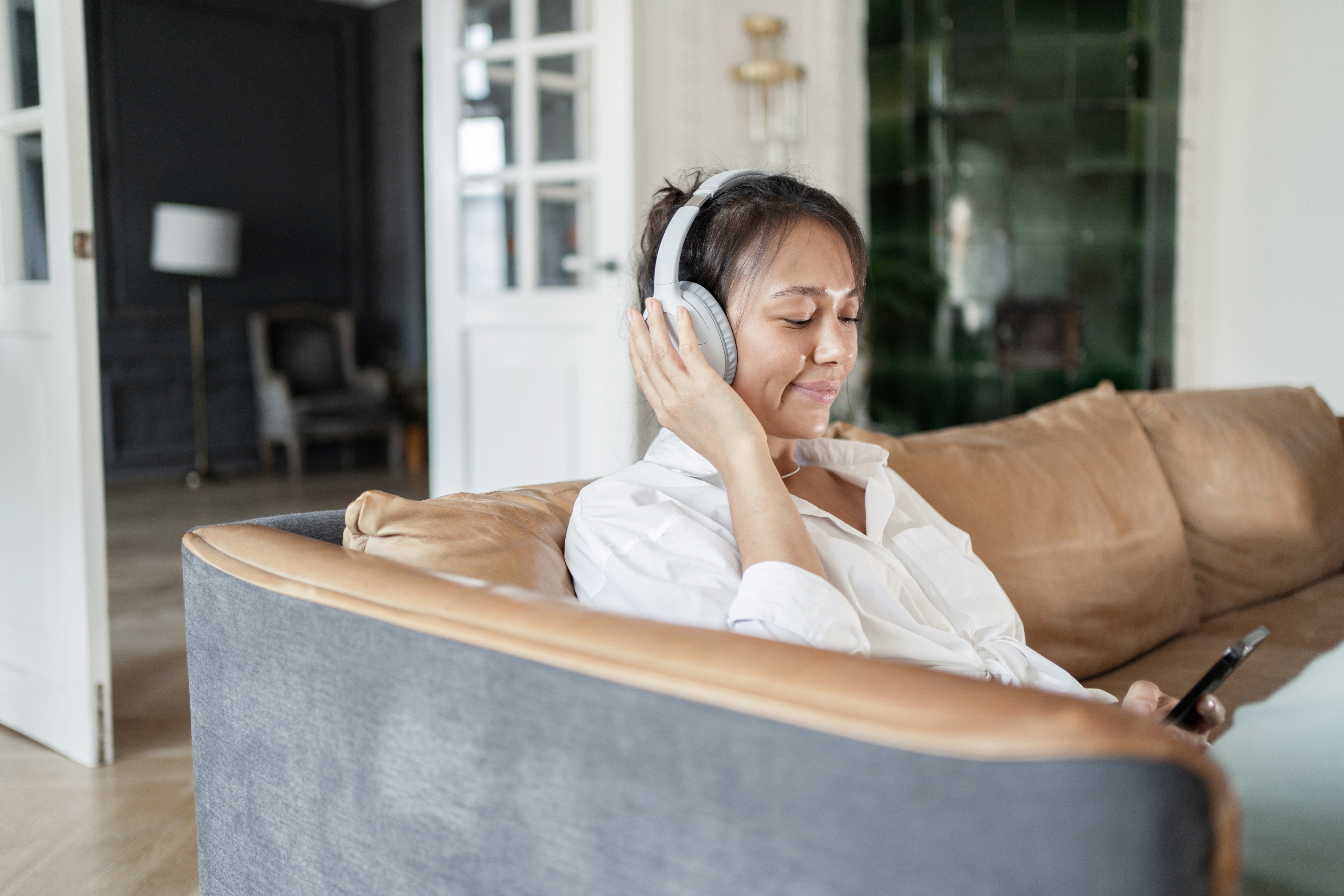 Woman using headphones listening to audiobook