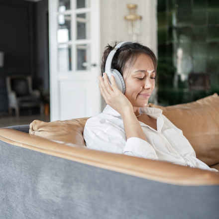 Woman using headphones listening to audiobook