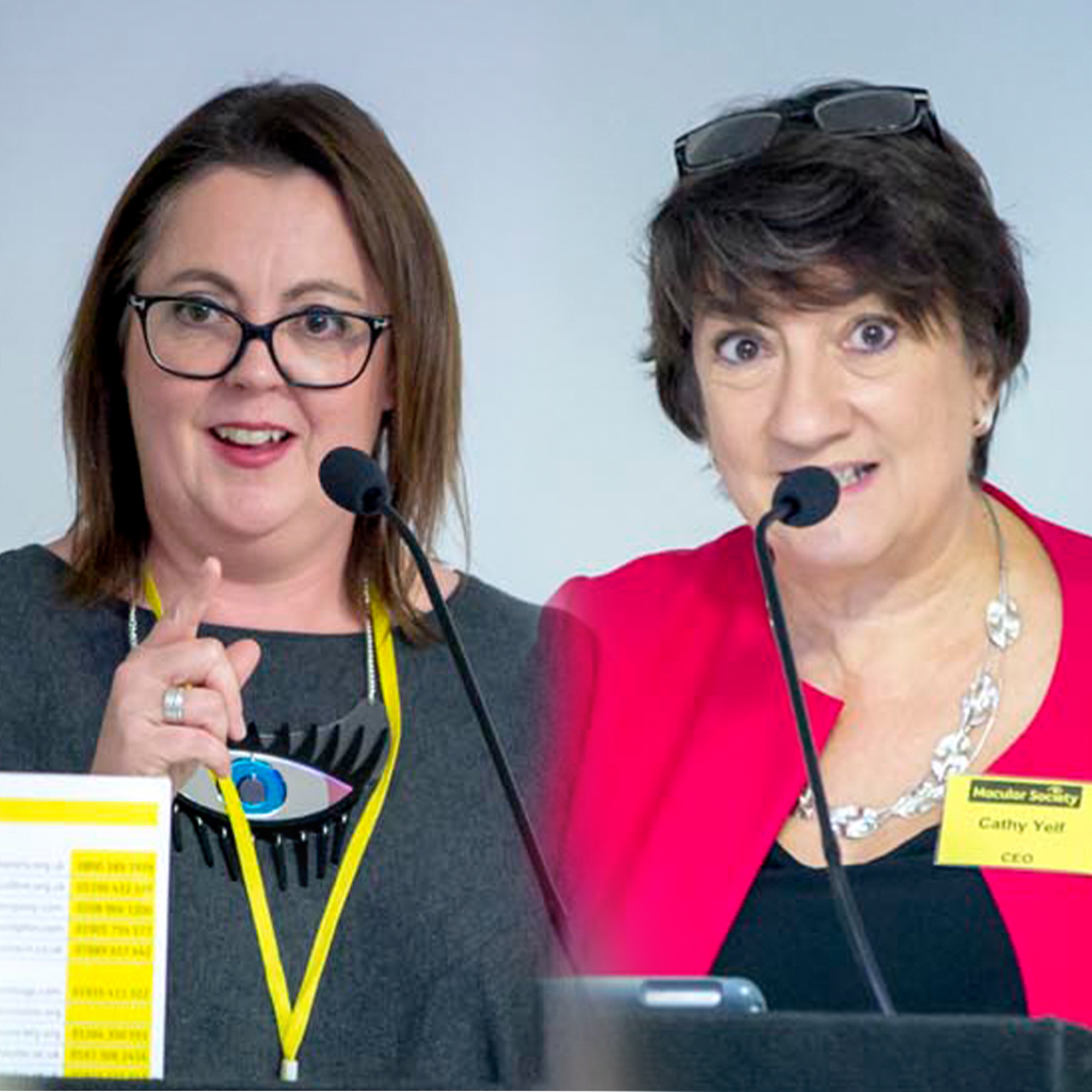 Cathy Yelf and researcher at conference speaking into microphones
