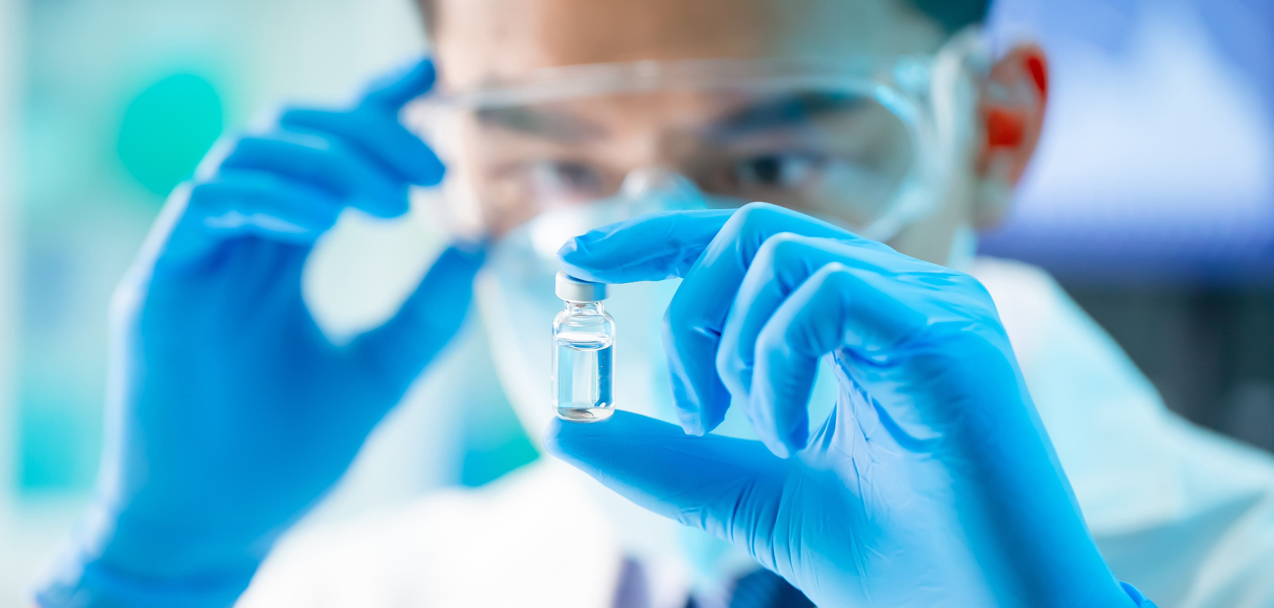 Scientist with drug vial