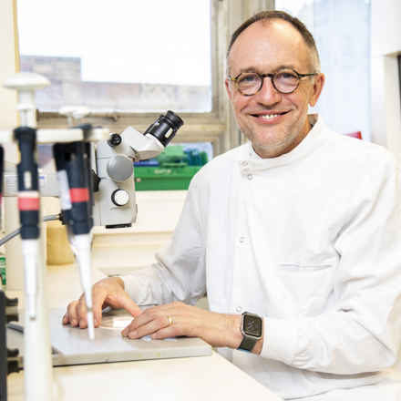 Andrew Dick in laboratory smiling at camera
