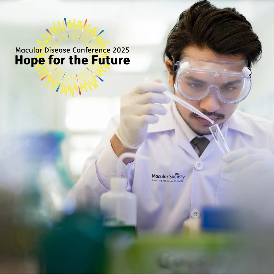 A dark-haired, male researcher wearing white overalls which includes the Macular Society logo. He is using a plunger to transfer liquid into a pipette. The Macular Society Conference logo sits in the top left corner.