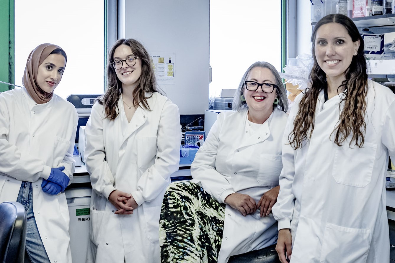 Dr Amanda Carr with her team smiling into the camera