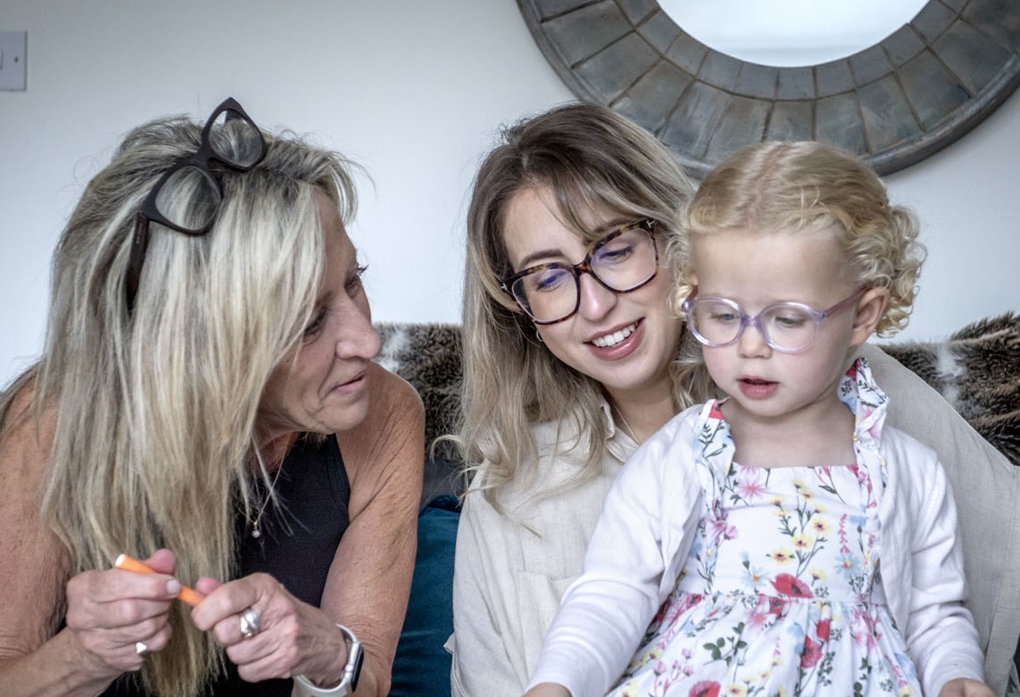 Gill with her daughter and granddaughter playing together