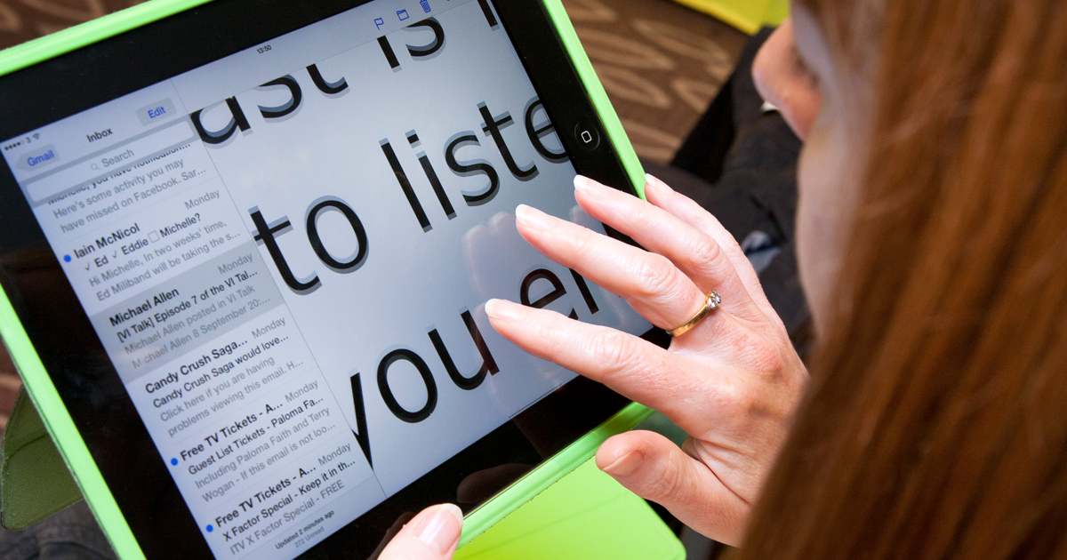 Woman using enlarged reading material on tablet