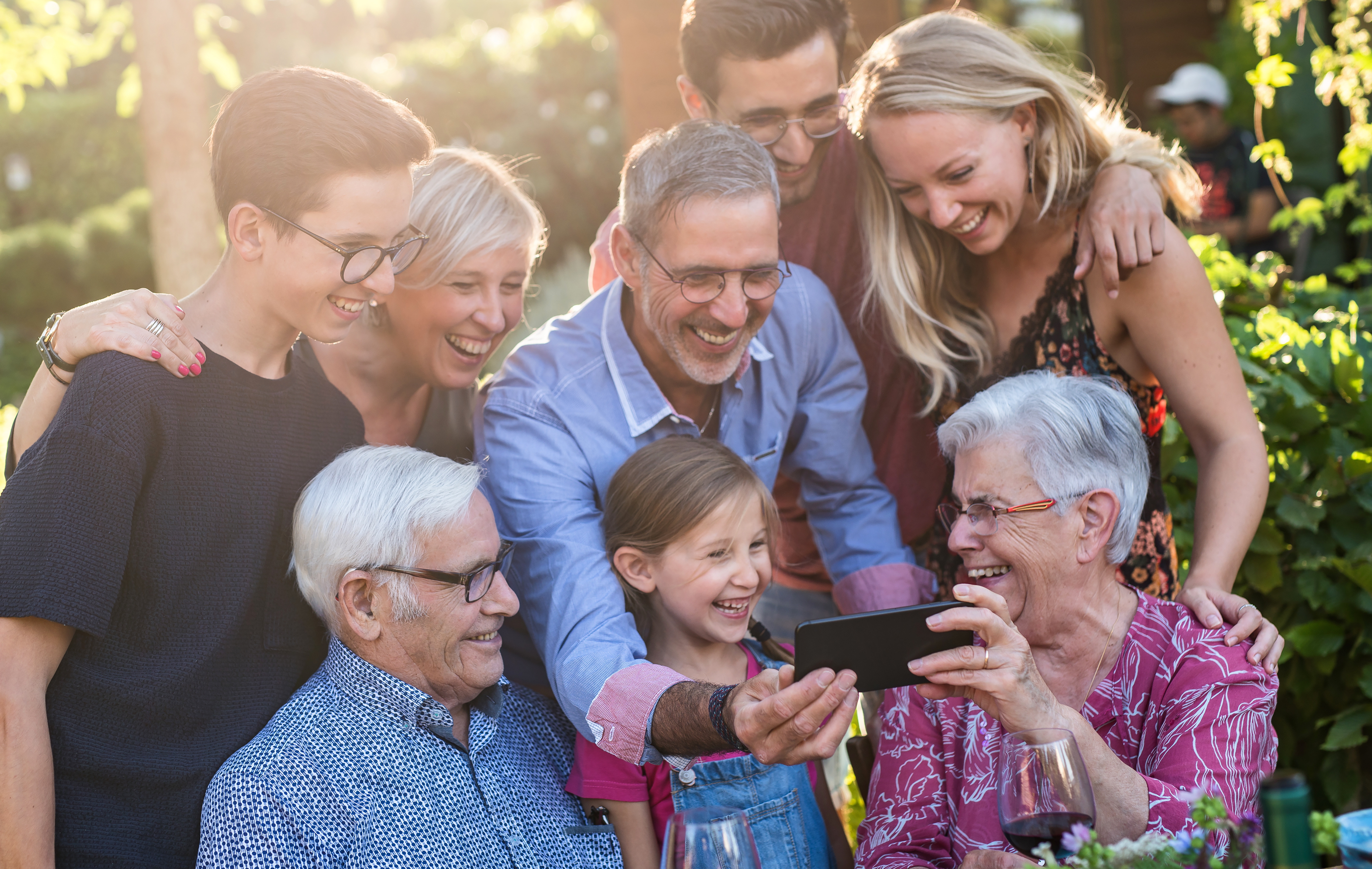 Family taking group photo in garden 