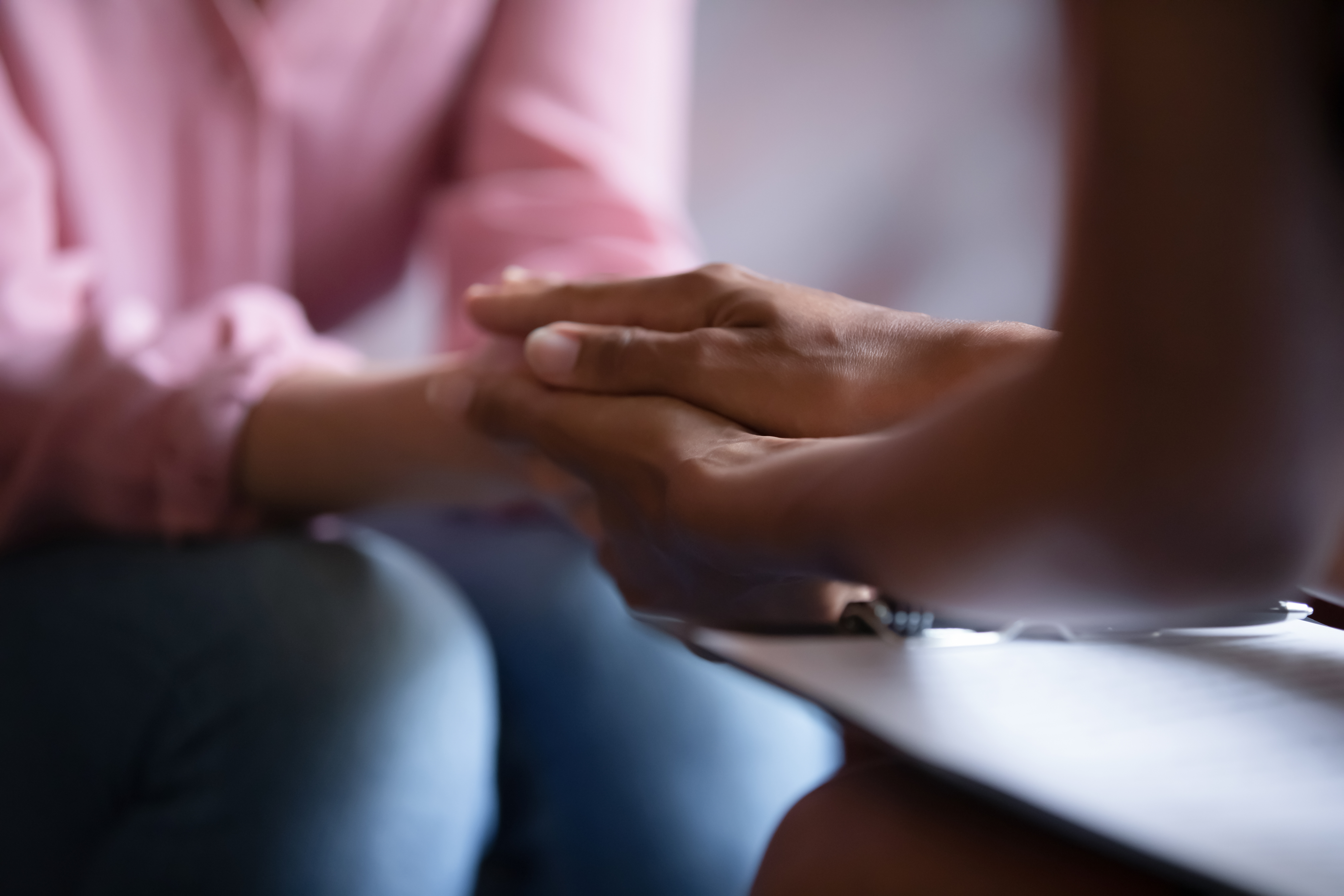 Person holding another's hand to reassure them