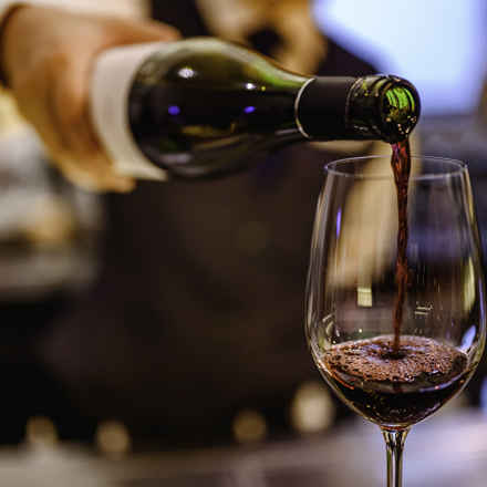 Pouring red wine into glass